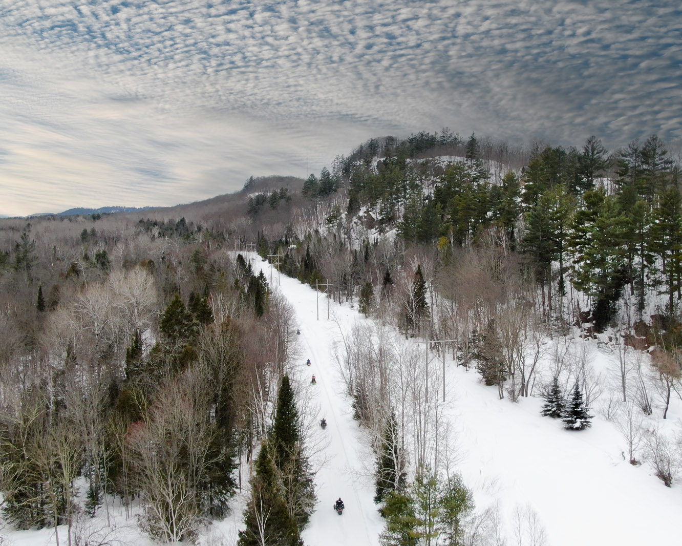 Snowmobilers on a groomed trail in the Porcupine Mountains area